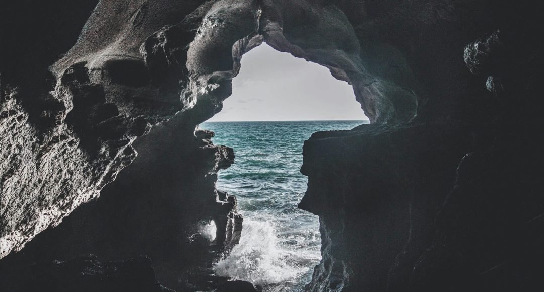 Stunning ocean view from a cave in Morocco, showcasing the play of light and shadow.